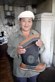 Lady holding a pair of hand-made Mongolian Boots